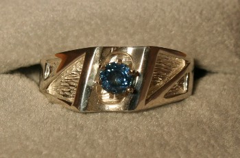 A mens gold ring set with a Montana Sapphire